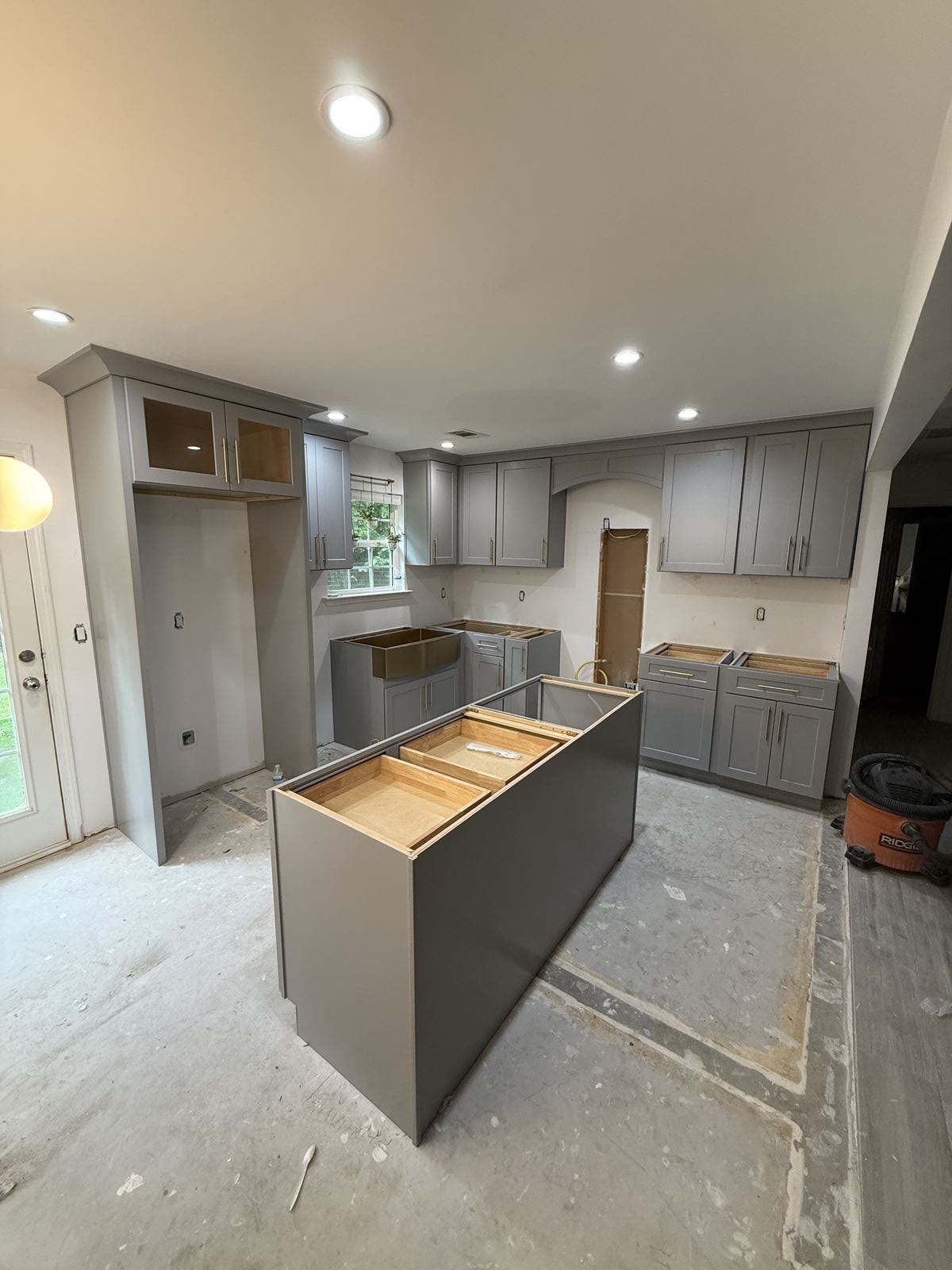 Shaker Grey cabinet installation paired with new countertops by Southeastern Granite Co